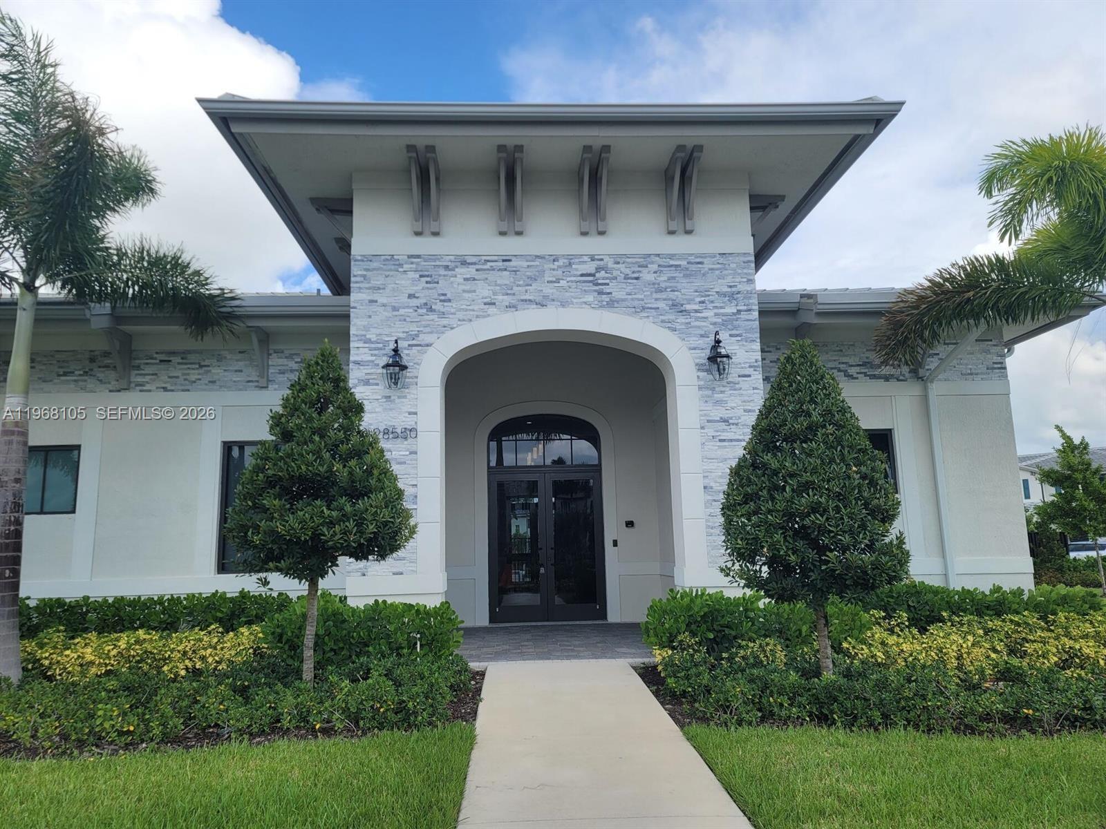 13402 Southwest 286th Street, Unit 13402 Homestead, FL 33033 - Photo 36 of 43 a front view of a house with lots of green space