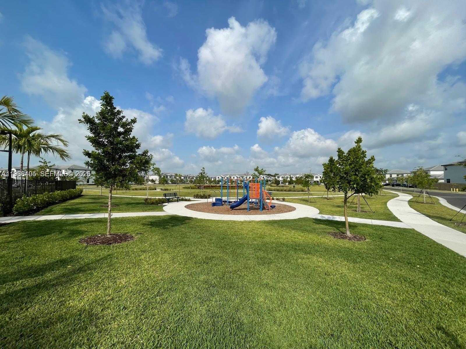 13402 Southwest 286th Street, Unit 13402 Homestead, FL 33033 - Photo 43 of 43 a view of a swimming pool with a yard