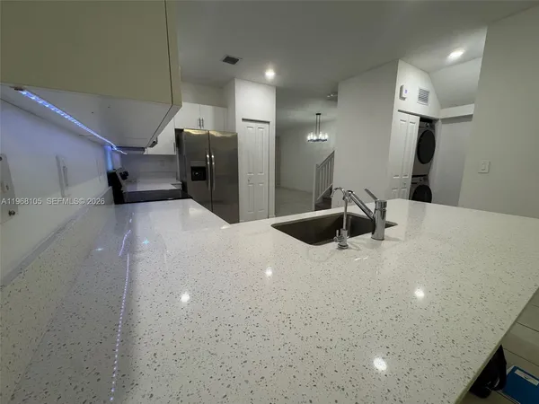 a large bathroom with a sink a toilet and mirror