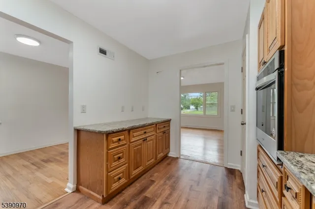 a view of a kitchen cabinets and wooden floor