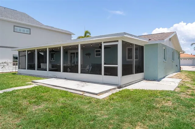 a view of a house with a yard and large window