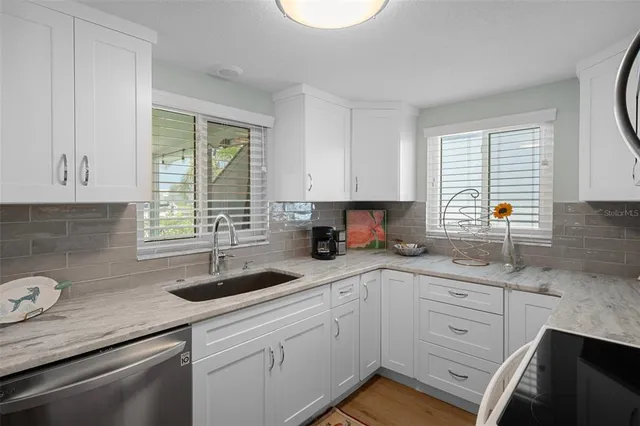a kitchen with sink cabinets and window