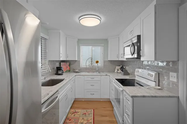a kitchen with a sink stove and cabinets