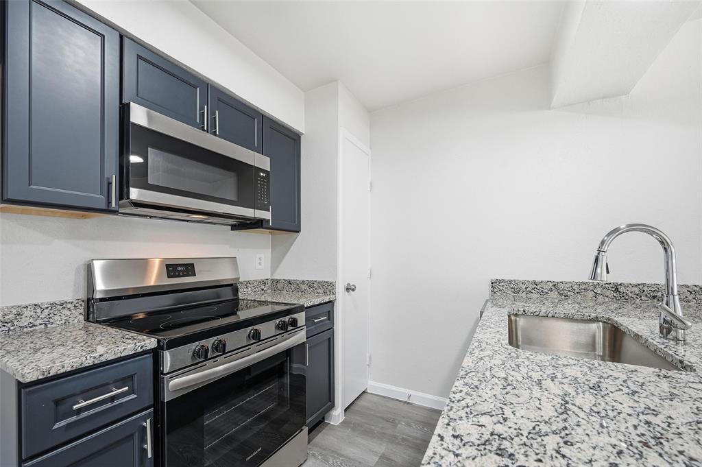 4851 Cedar Springs Road, Unit 189 Dallas, TX 75219 - Photo 7 of 29 a kitchen with stainless steel appliances granite countertop a stove microwave and sink