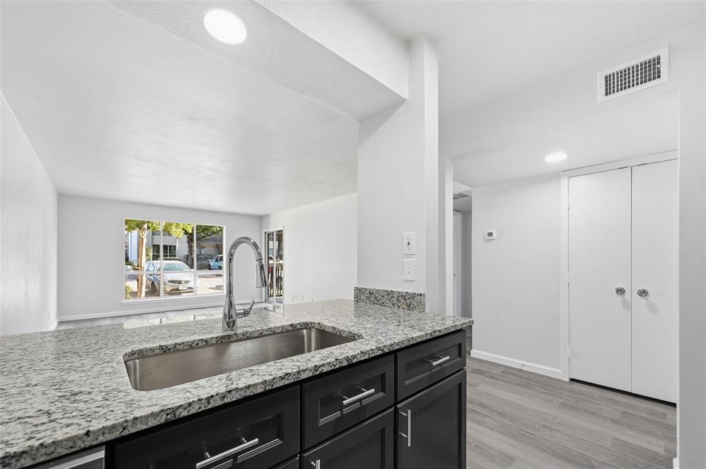 4851 Cedar Springs Road, Unit 189 Dallas, TX 75219 - Photo 9 of 29 a bathroom with granite countertop double vanity and a mirror