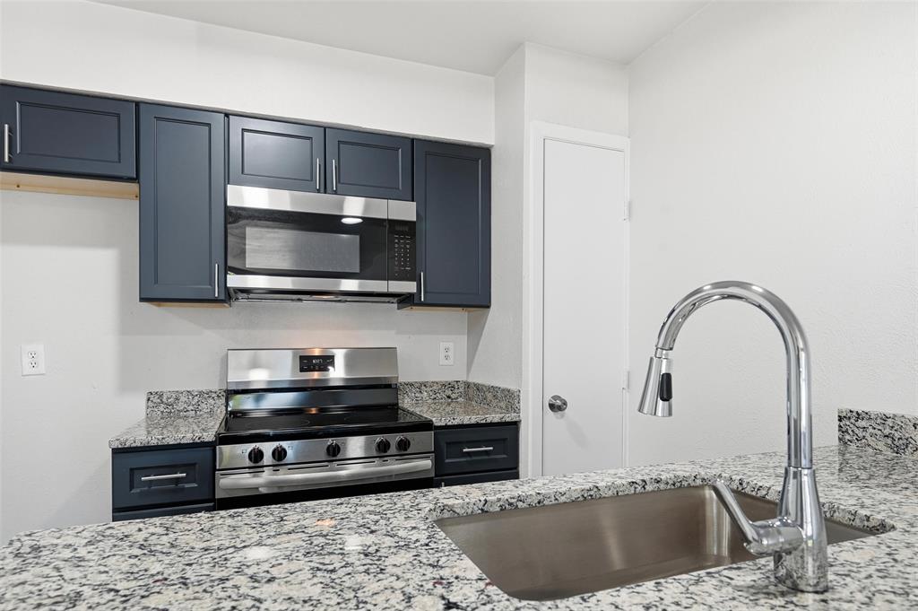 4851 Cedar Springs Road, Unit 189 Dallas, TX 75219 - Photo 10 of 29 a kitchen with stainless steel appliances granite countertop a sink a stove and microwave