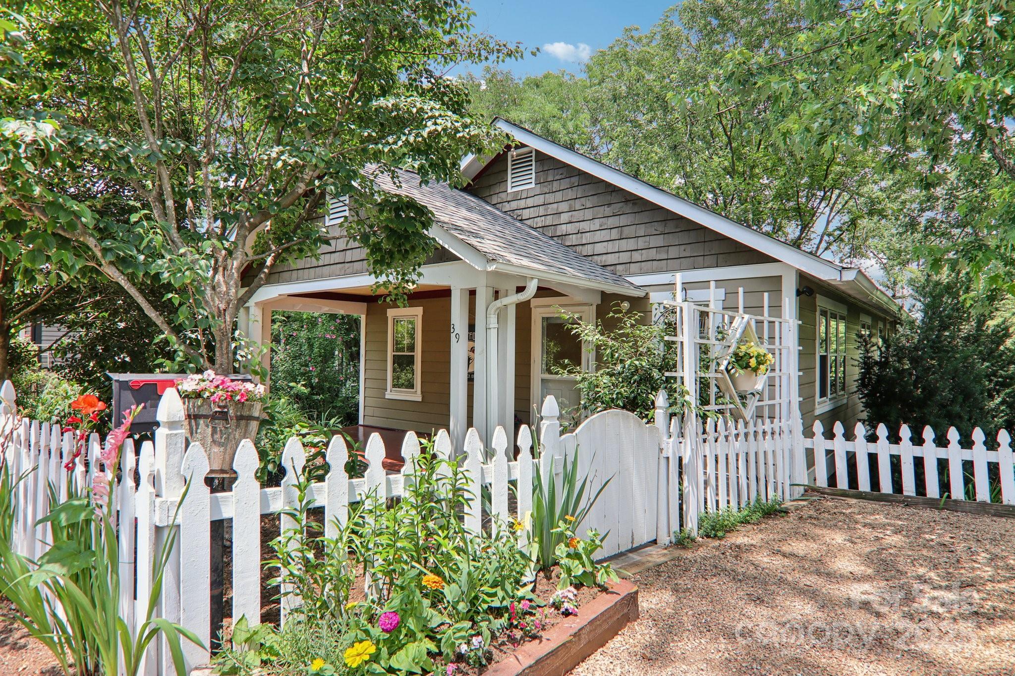 a front view of a house with a garden