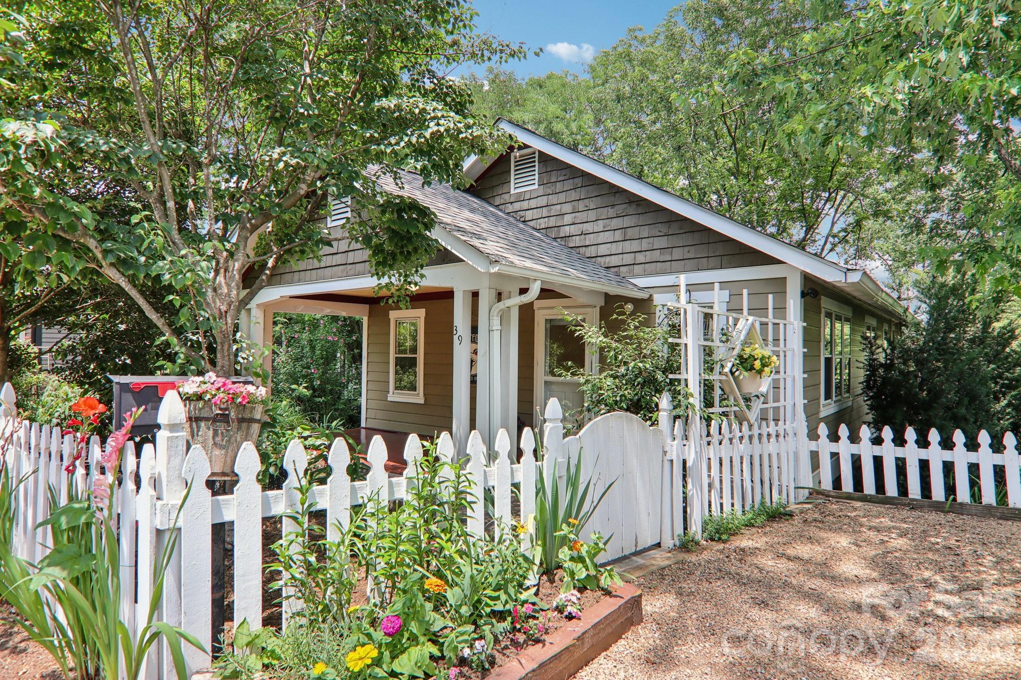 a front view of a house with a garden