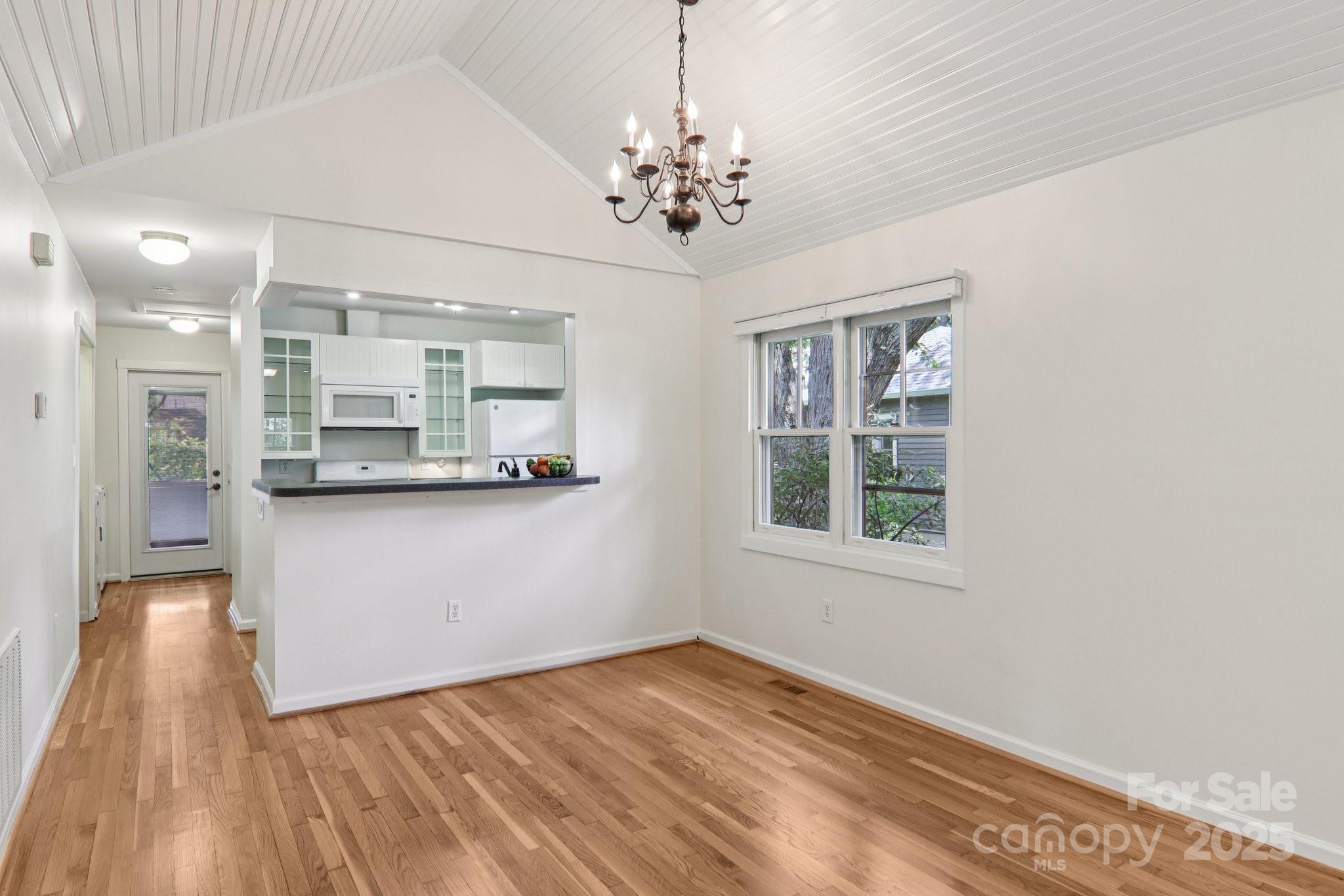 39 Short Street Asheville, NC 28801 - Photo 12 of 47 a view of an empty room with a window and wooden floor