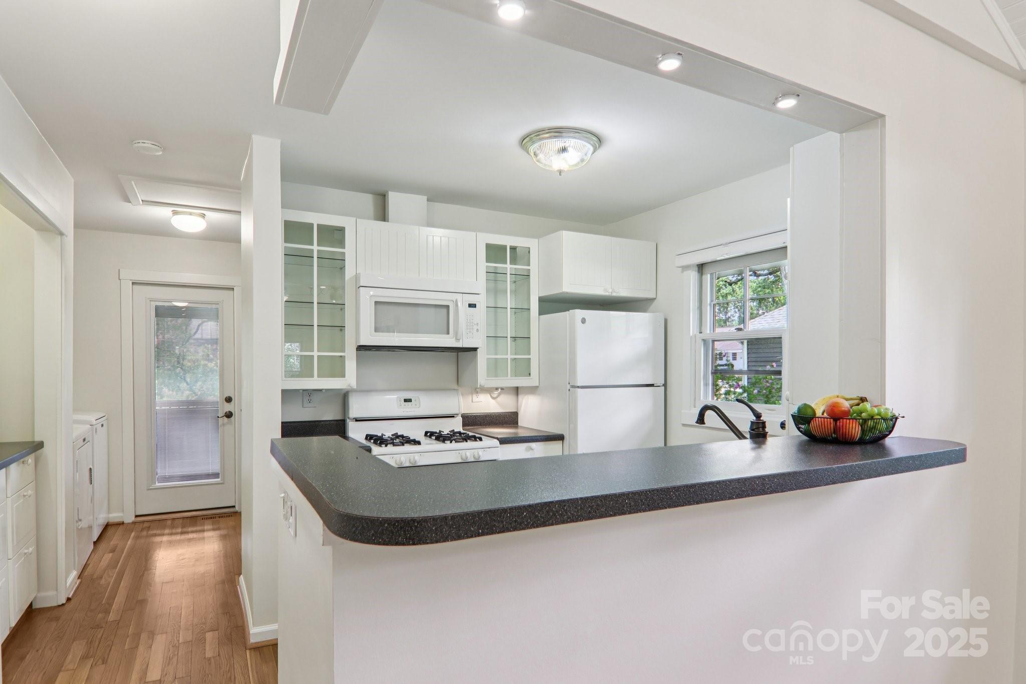 39 Short Street Asheville, NC 28801 - Photo 13 of 47 a kitchen with stainless steel appliances a sink a stove and a refrigerator