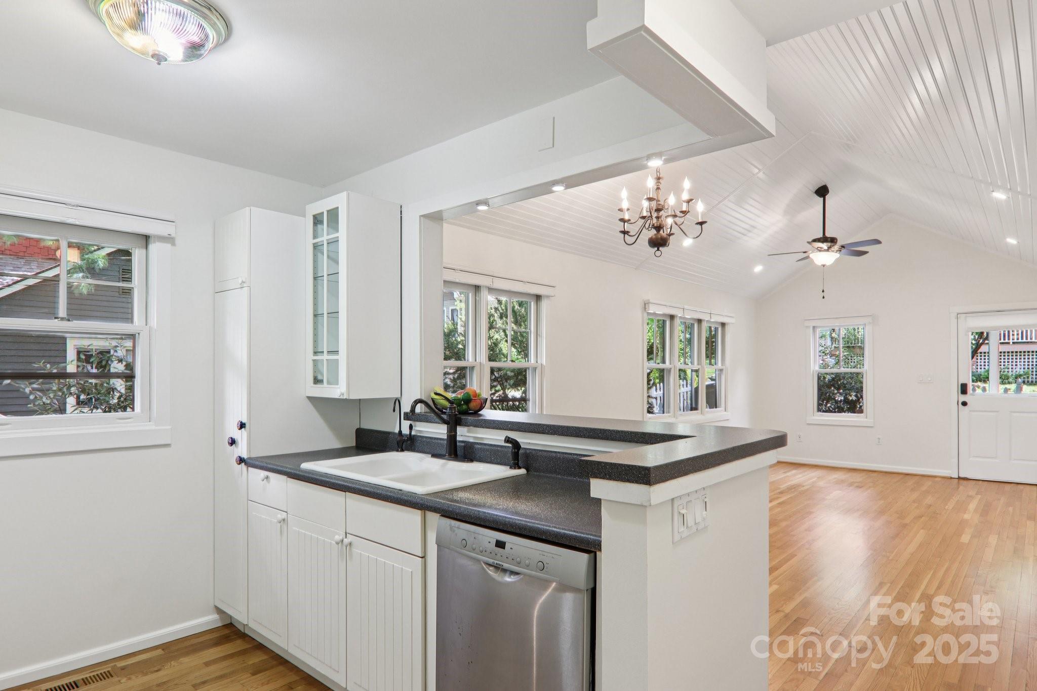 39 Short Street Asheville, NC 28801 - Photo 14 of 47 a kitchen with granite countertop a sink cabinets and wooden floor