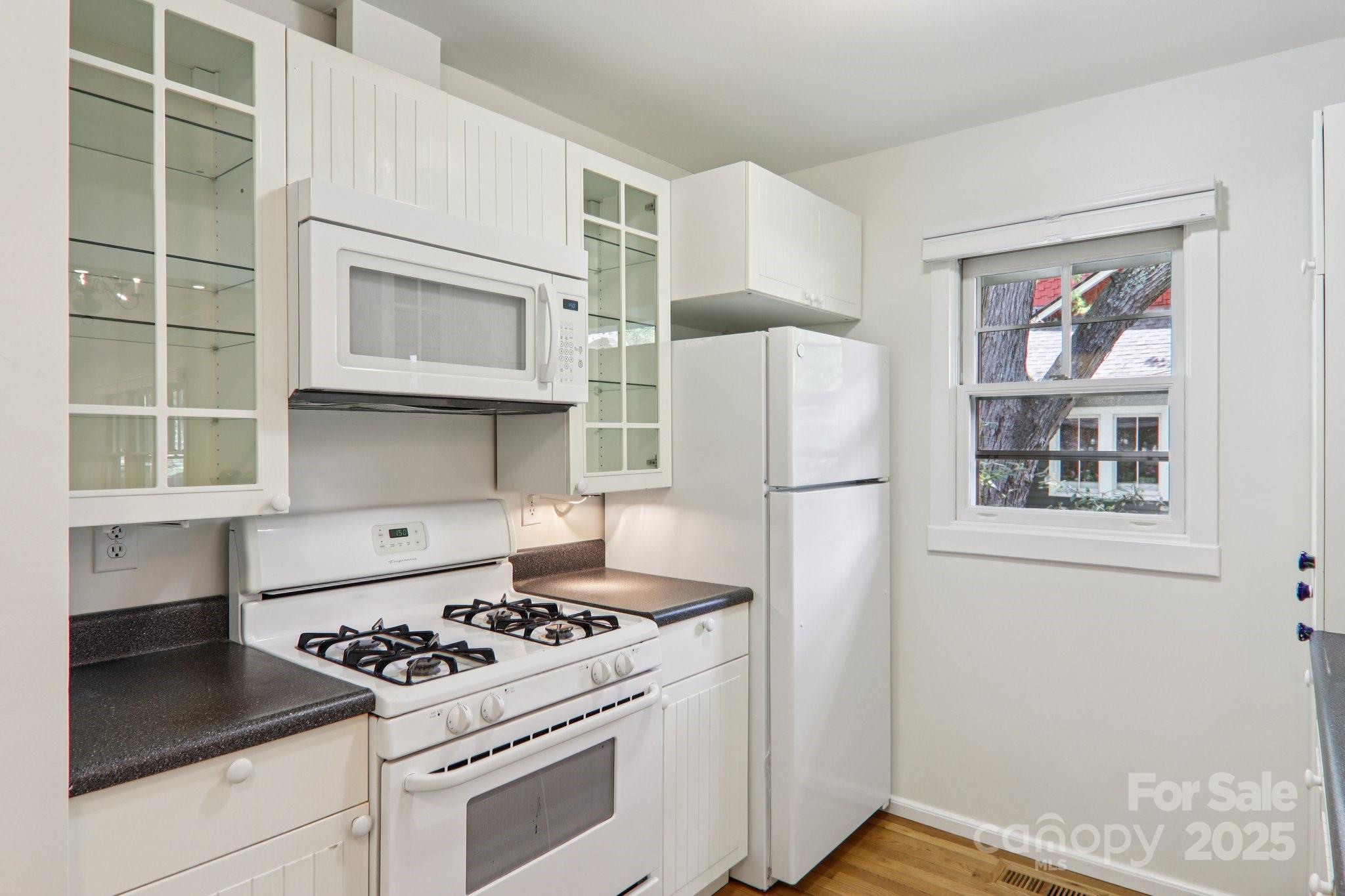 39 Short Street Asheville, NC 28801 - Photo 15 of 47 a kitchen with a stove a refrigerator and a window