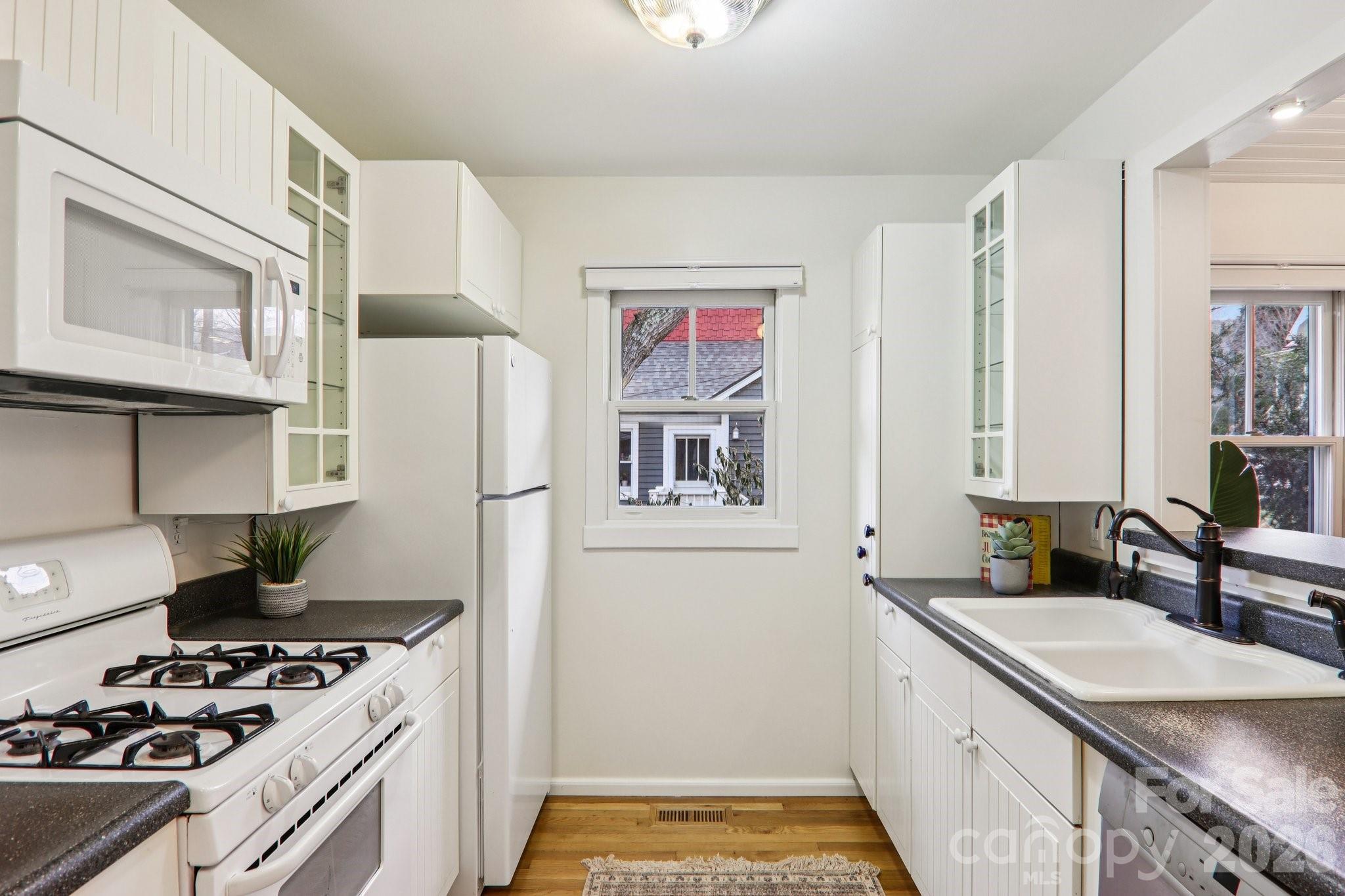 39 Short Street Asheville, NC 28801 - Photo 15 of 39 a kitchen with stainless steel appliances a stove a sink and a refrigerator