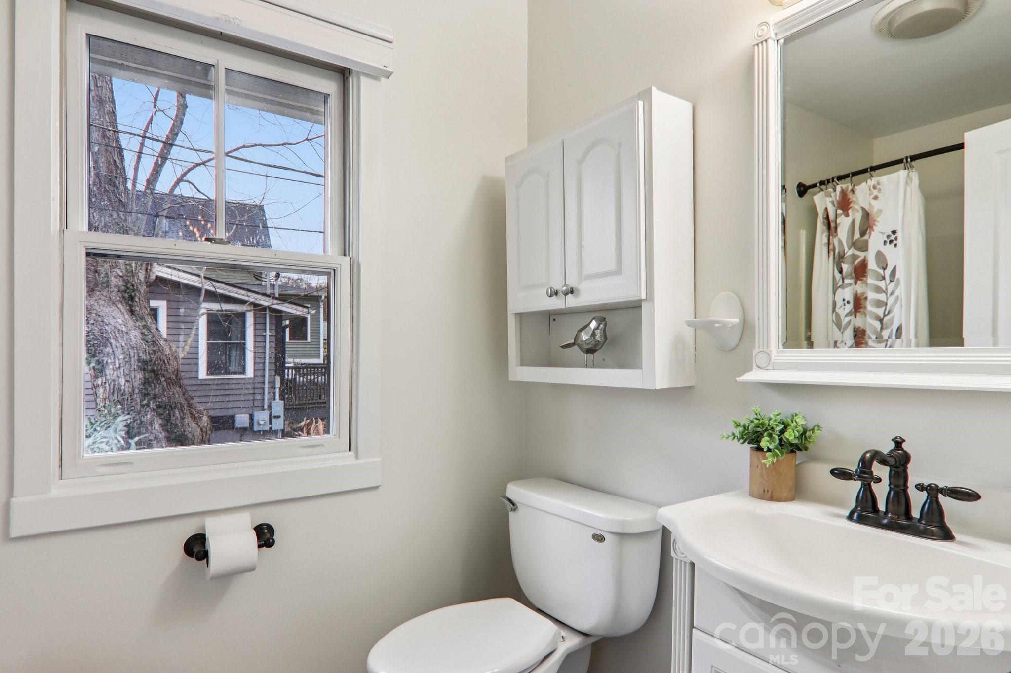 39 Short Street Asheville, NC 28801 - Photo 23 of 39 a bathroom with a toilet a sink and a window