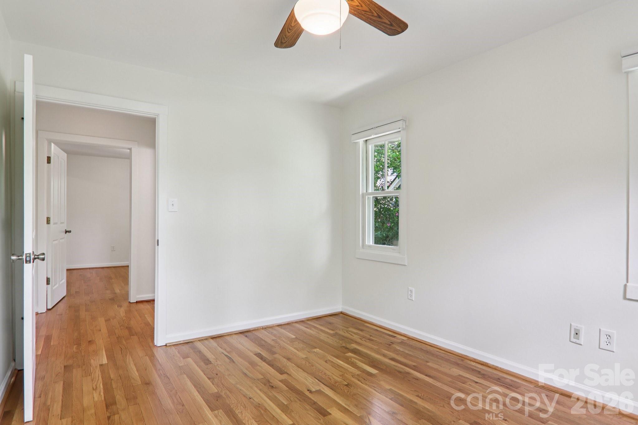 39 Short Street Asheville, NC 28801 - Photo 25 of 39 wooden floor in an empty room with a window