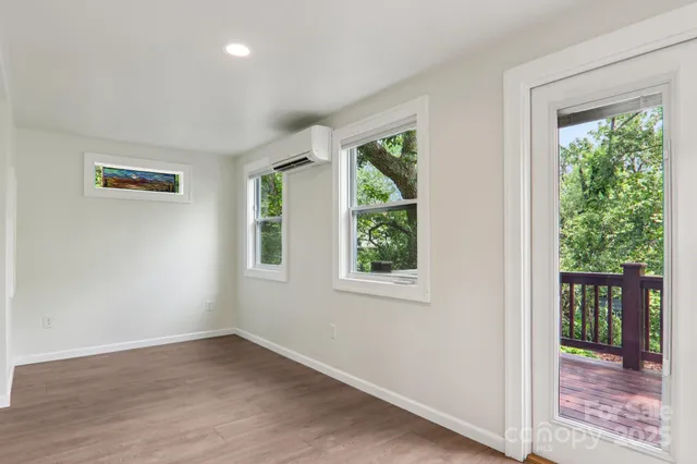 an empty room with windows and closet
