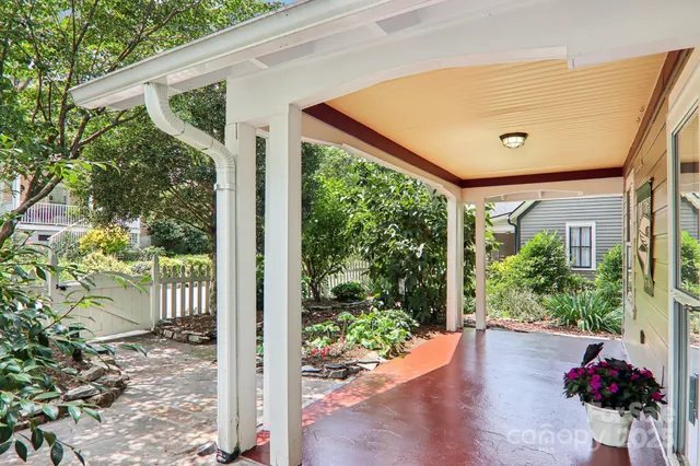 a view of a house with a small yard and wooden fence