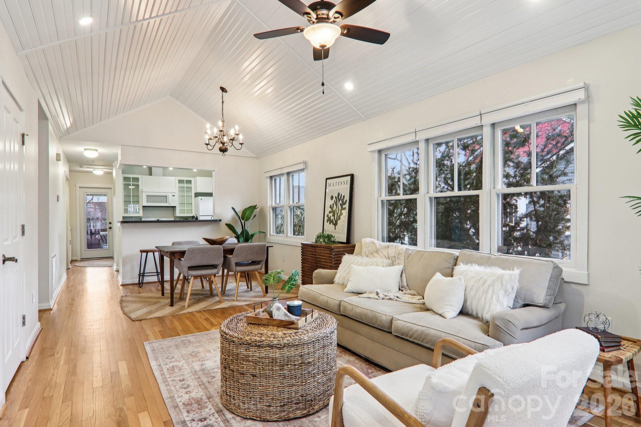 39 Short Street Asheville, NC 28801 - Photo 9 of 39 a living room with furniture a chandelier and a window
