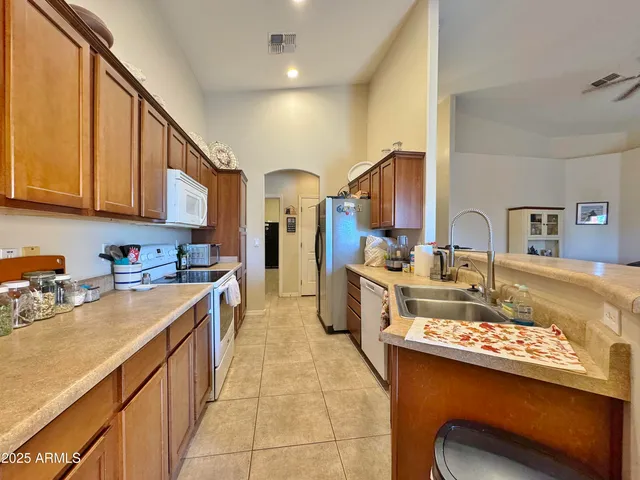a kitchen filled a sink and a stove top oven