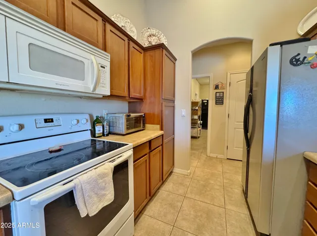 a kitchen with stainless steel appliances granite countertop a refrigerator and cabinets
