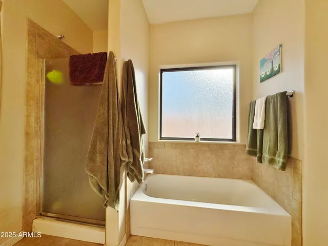 a bathroom with a tub and a shower