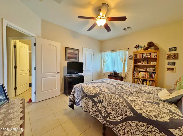 a bedroom with a bed a dresser and a book shelf