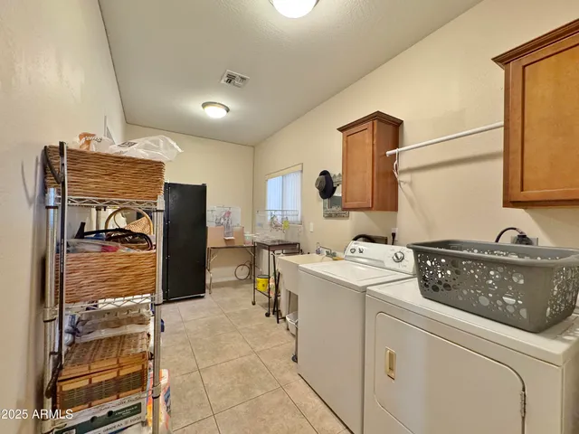 a utility room with sink dryer and washer