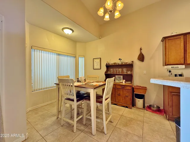 a view of a dining room with furniture and chandelier