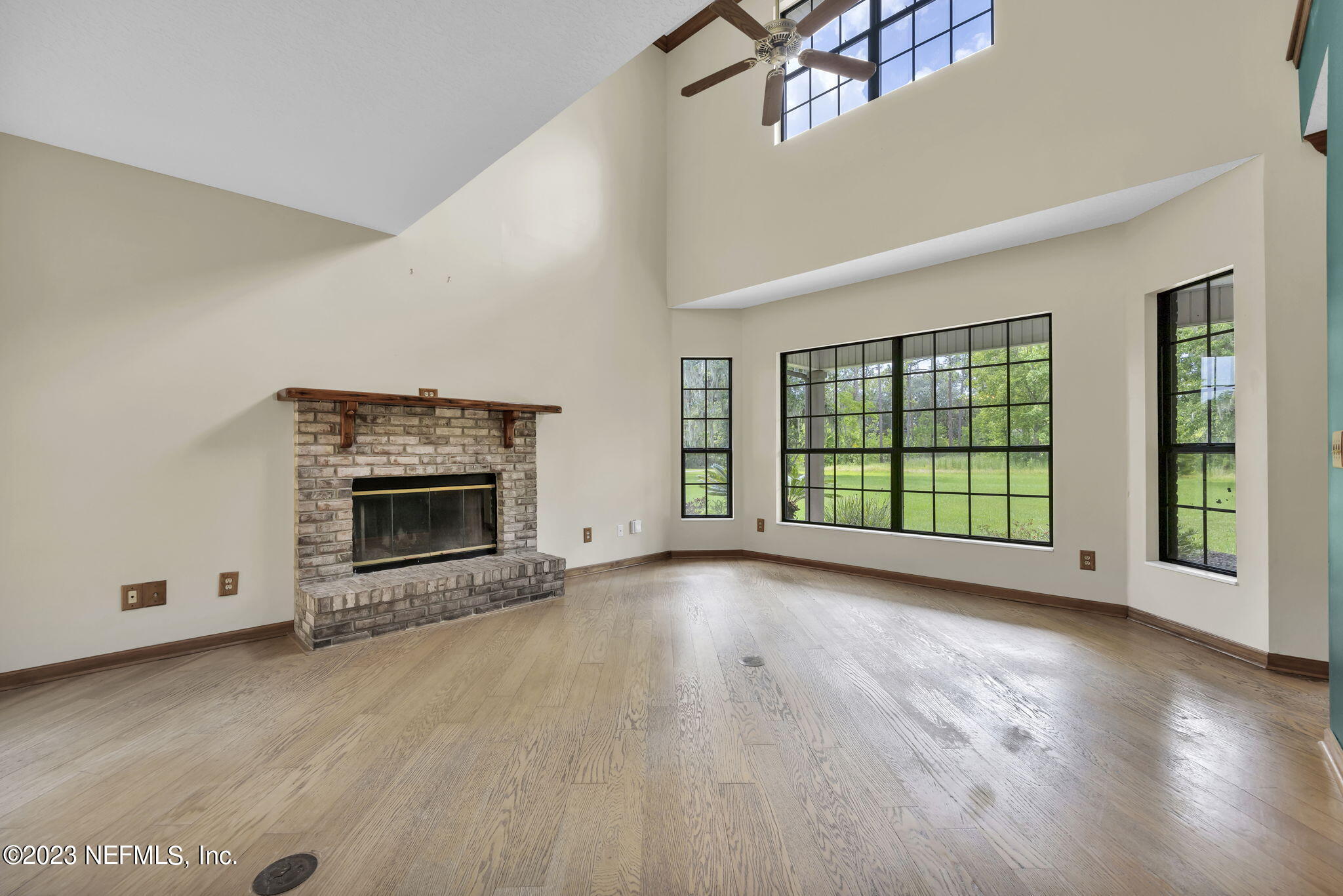 1387 Lee Road St. Johns, FL 32259 - Photo 12 of 62 wooden floor fireplace and windows in an empty room