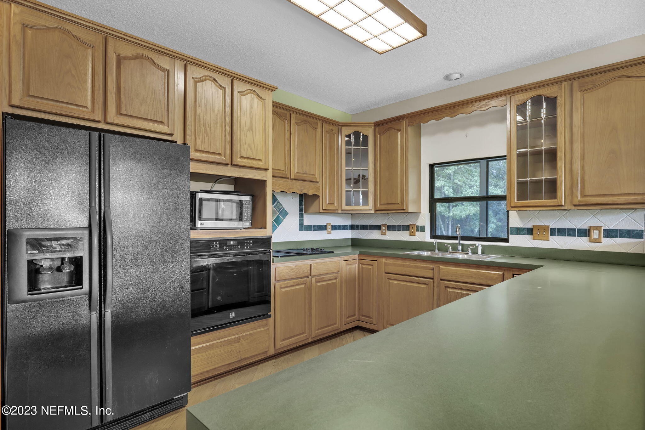 1387 Lee Road St. Johns, FL 32259 - Photo 18 of 62 a kitchen with stainless steel appliances granite countertop a refrigerator a stove and a sink with cabinets