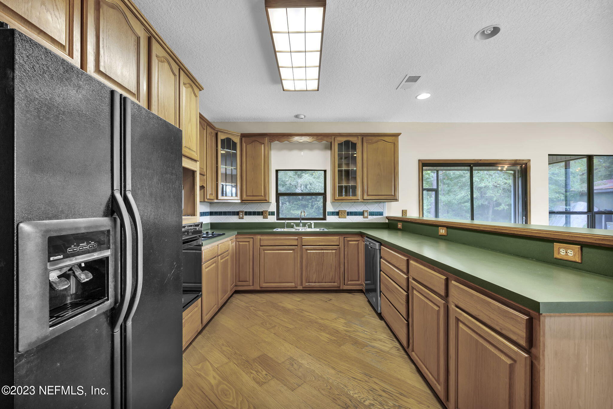 1387 Lee Road St. Johns, FL 32259 - Photo 19 of 62 a kitchen with stainless steel appliances granite countertop a sink stove and refrigerator
