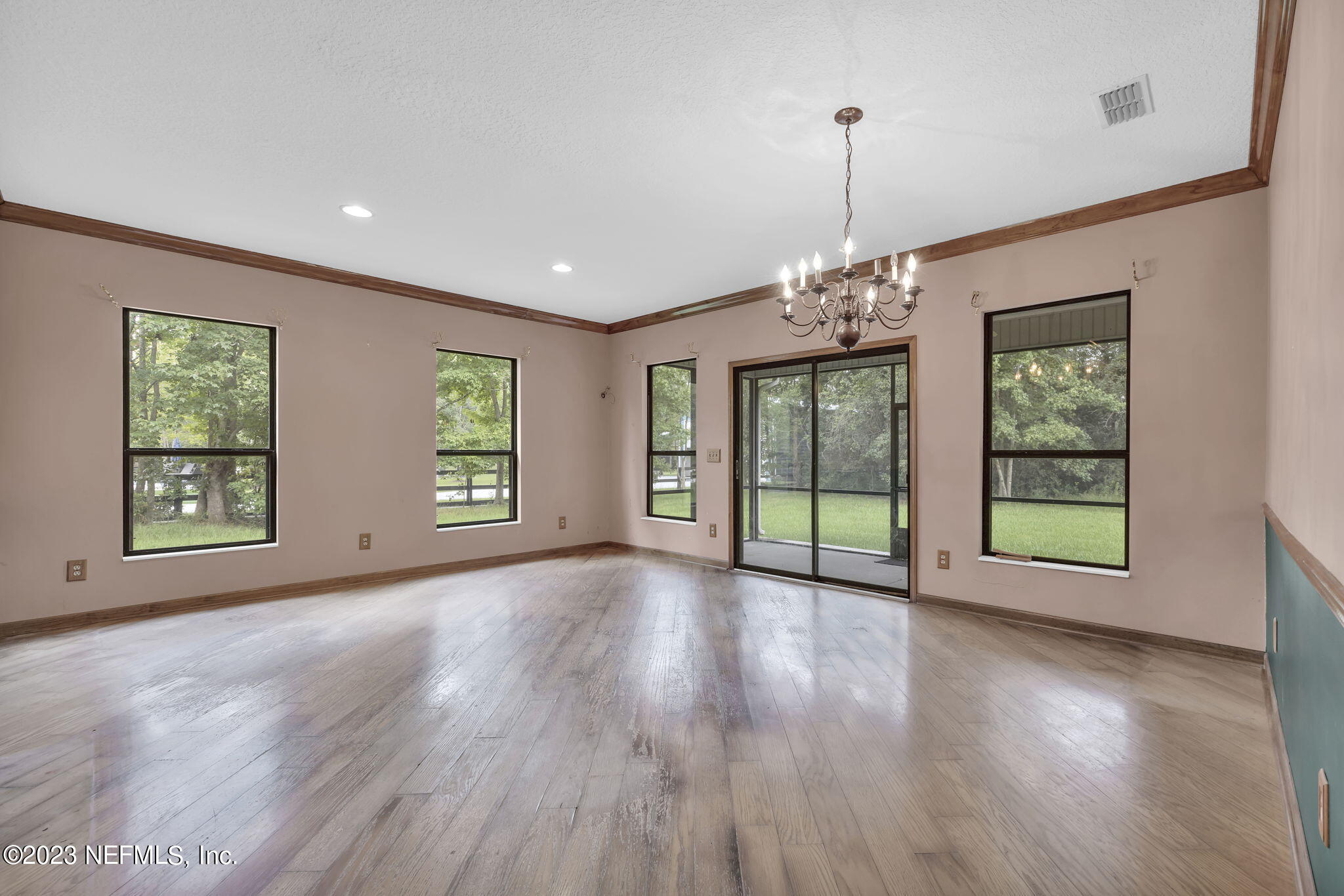 1387 Lee Road St. Johns, FL 32259 - Photo 22 of 62 a view of an empty room with wooden floor and a window