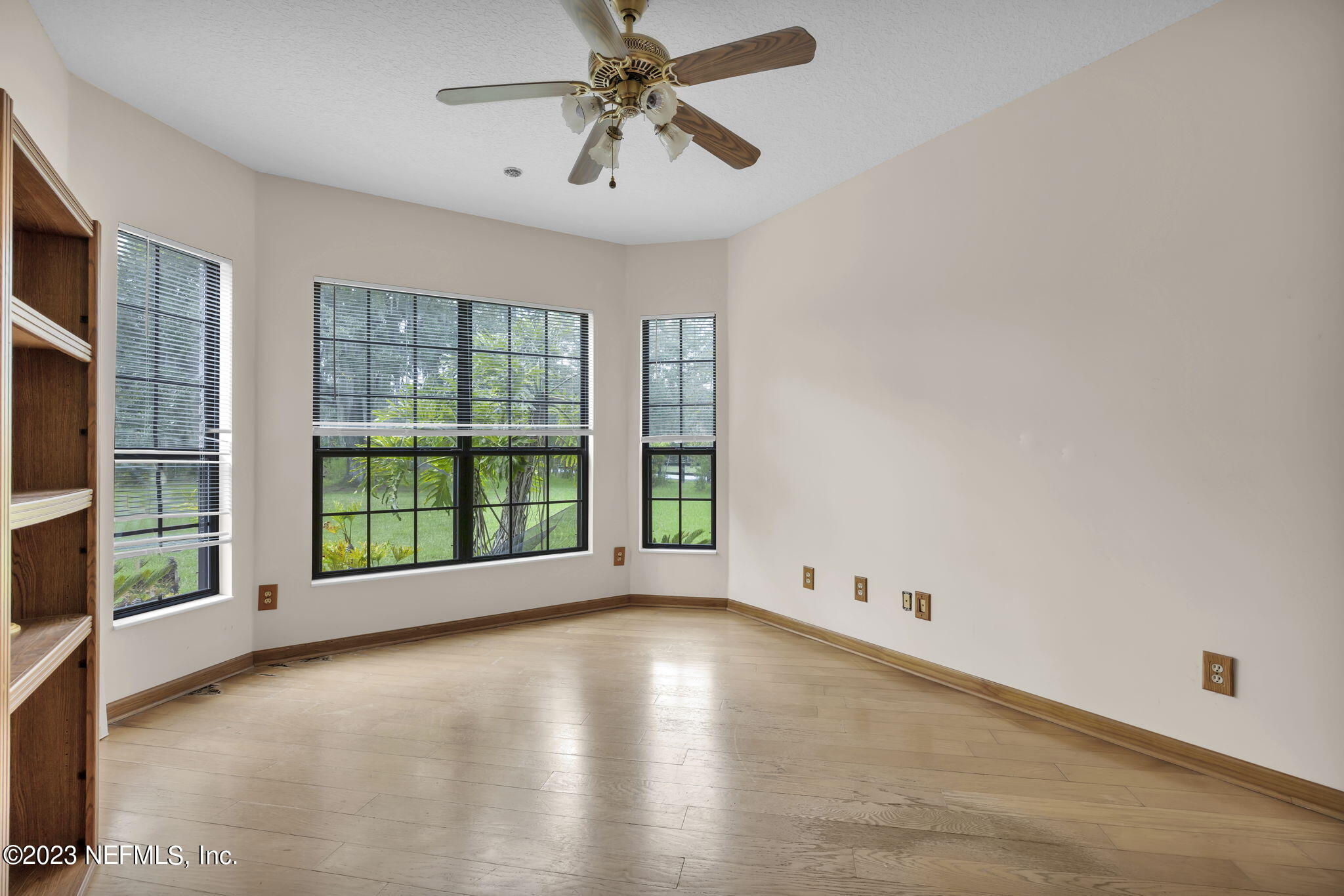 1387 Lee Road St. Johns, FL 32259 - Photo 24 of 62 a view of an empty room with a window and wooden floor