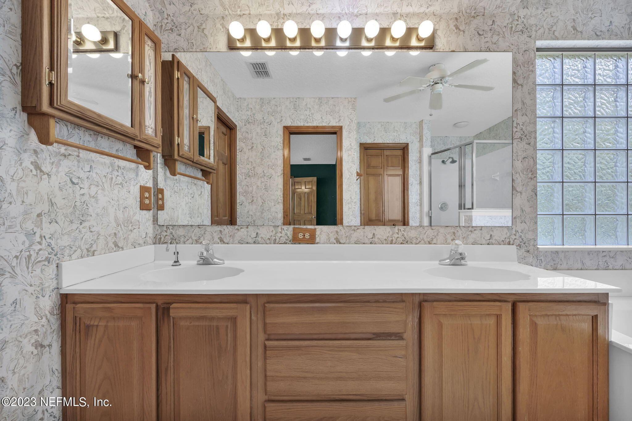 1387 Lee Road St. Johns, FL 32259 - Photo 31 of 62 a bathroom with a granite countertop sink and a mirror