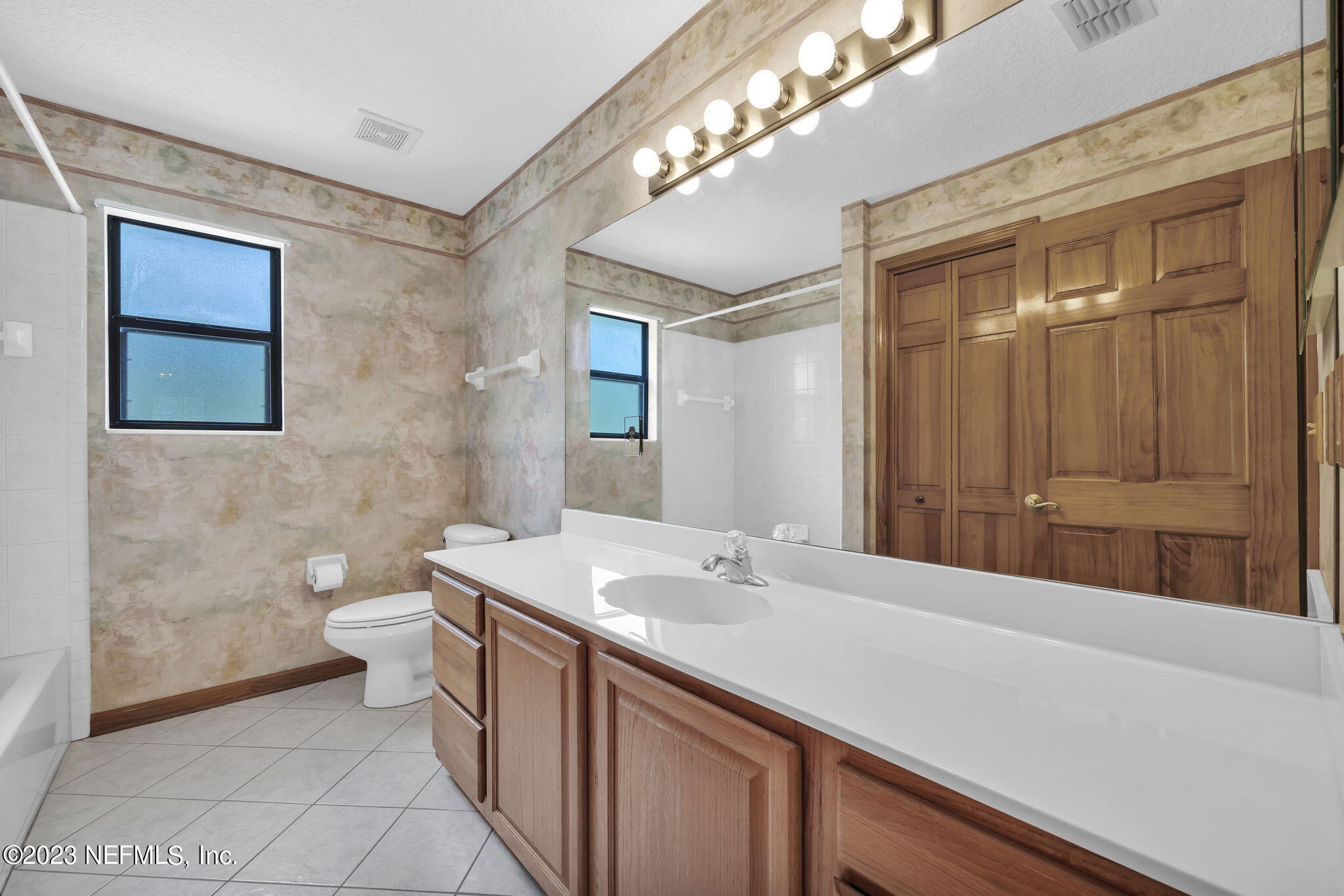 1387 Lee Road St. Johns, FL 32259 - Photo 36 of 62 a bathroom with a double vanity sink a toilet and a mirror