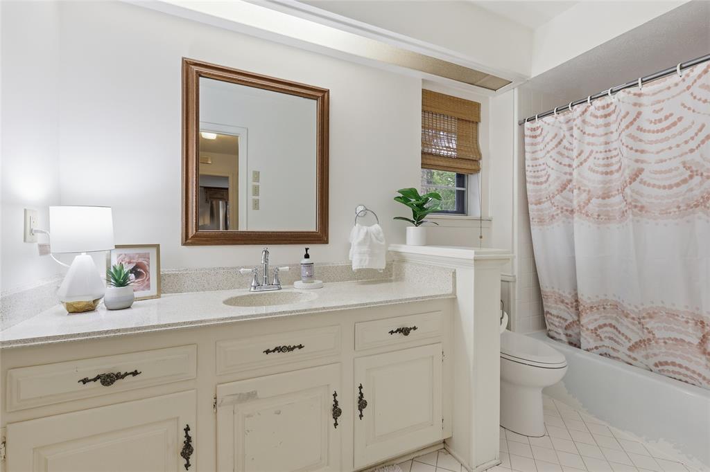 823 Ridgecrest Circle Denton, TX 76205 - Photo 31 of 40 Bathroom featuring a single vanity with an integrated sink, polished chrome faucet, and ample under-cabinet storage