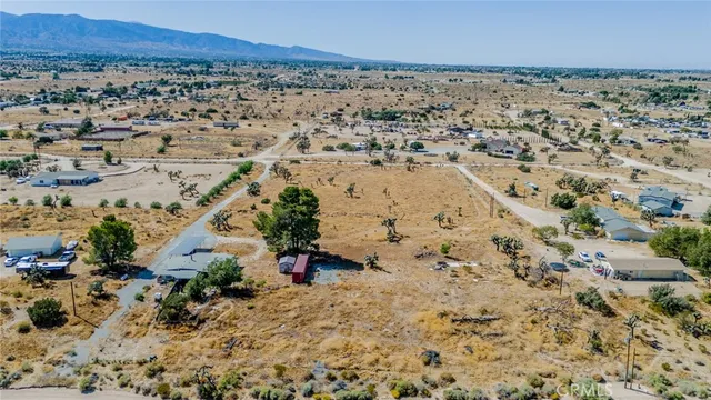 an aerial view of residential house and sandy dunes