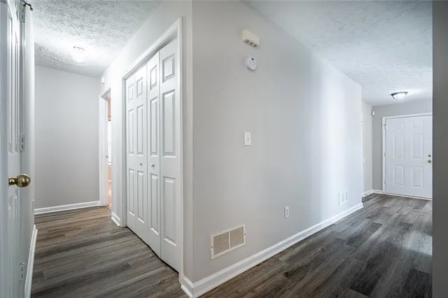 a view of a hallway with wooden floor