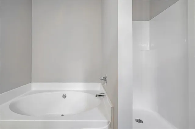 a white bath tub and shower