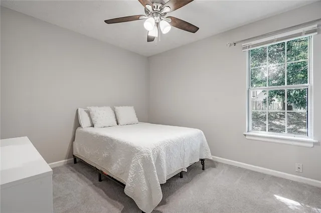 a bedroom with a bed and window