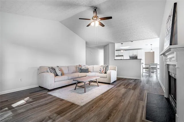 a living room with furniture fireplace and a chandelier