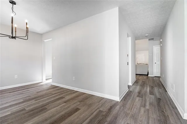 a view of a room with wooden floor