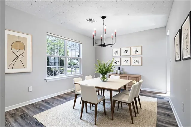 a view of a dining room with furniture window and wooden floor