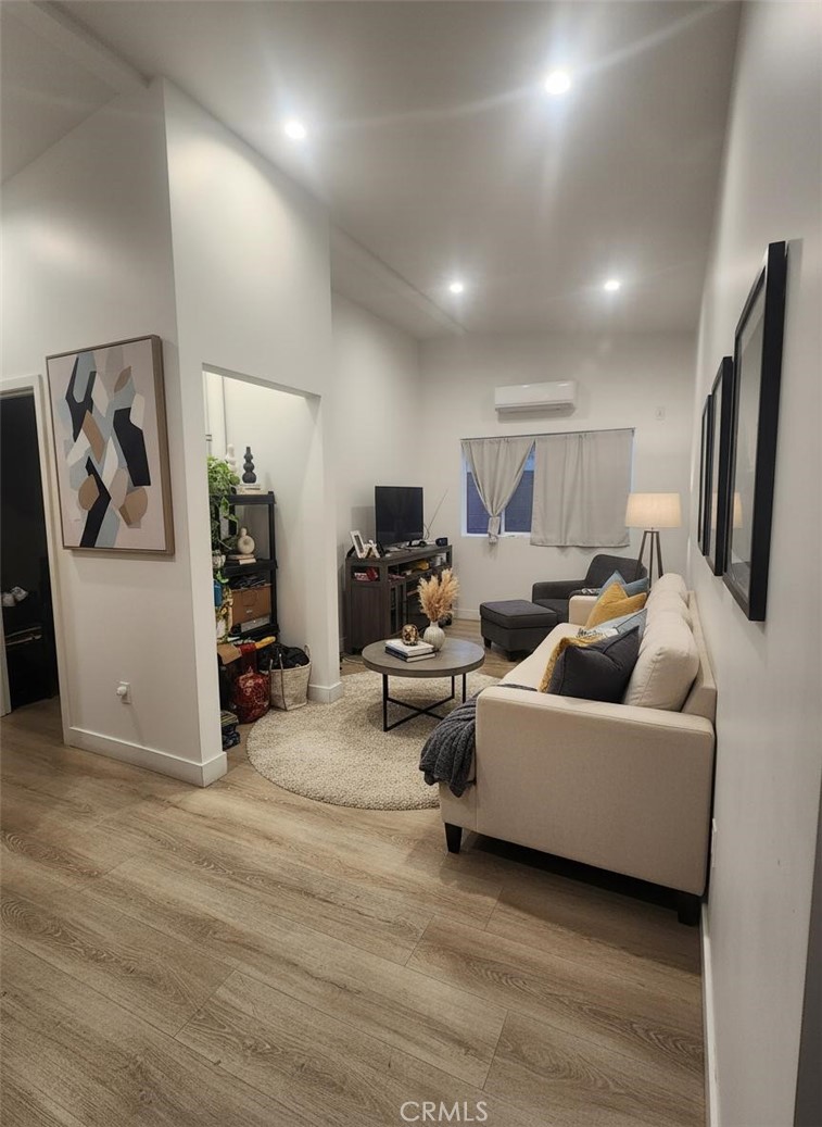 6836 Colmar Avenue, Unit 1/4 Bell Gardens, CA 90201 - Photo 1 of 6 a living room with furniture and a flat screen tv