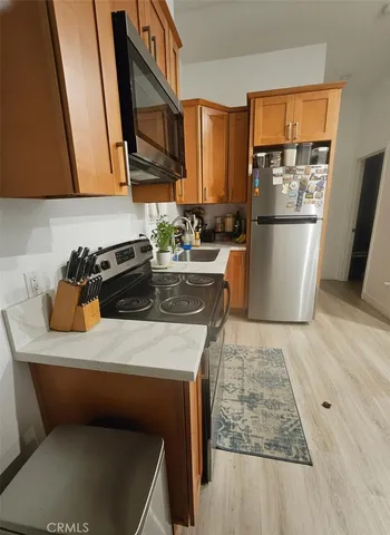 a kitchen with a sink a stove and a refrigerator