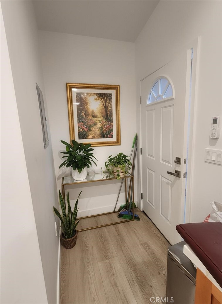 6836 Colmar Avenue, Unit 1/4 Bell Gardens, CA 90201 - Photo 6 of 6 a view of a hallway with paintings on the wall