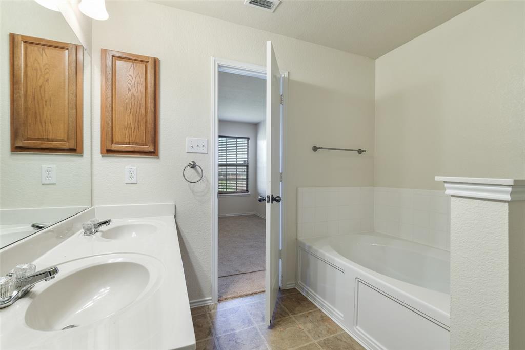 3917 Mantis Street Fort Worth, TX 76106 - Photo 13 of 22 a bathroom with a sink a toilet and bathtub