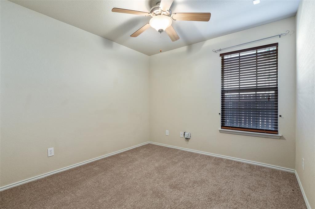 3917 Mantis Street Fort Worth, TX 76106 - Photo 14 of 22 an empty room with a window and a ceiling fan