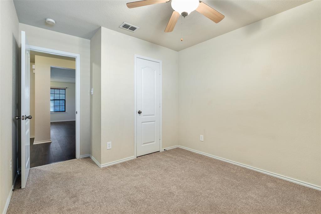 3917 Mantis Street Fort Worth, TX 76106 - Photo 15 of 22 an empty room with a ceiling fan and a window
