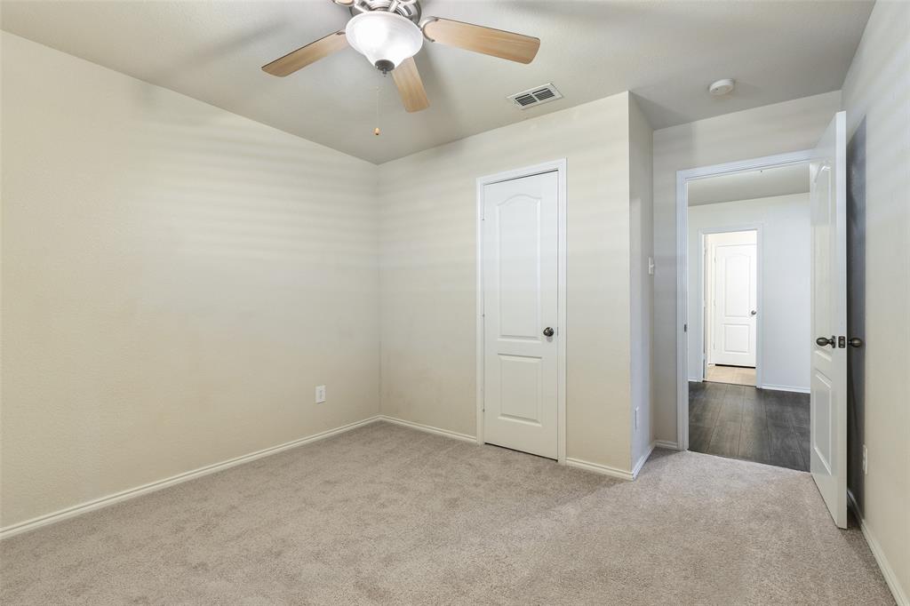 3917 Mantis Street Fort Worth, TX 76106 - Photo 16 of 22 an empty room with a empty space and a ceiling fan